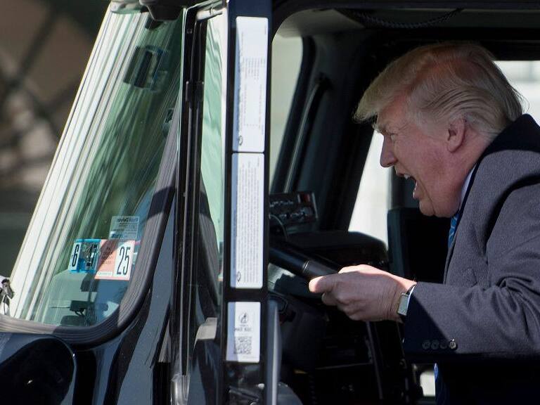 TOPSHOT - US President Donald Trump sits in the drivers seat of a semi-truck as he welcomes truckers and CEOs to the White House in Washington, DC, March 23, 2017, to discuss healthcare. / AFP PHOTO / JIM WATSON (Photo credit should read JIM WATSON/AFP via Getty Images)